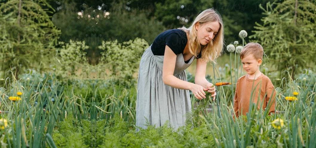 Woman and child in a garden, tending to plants